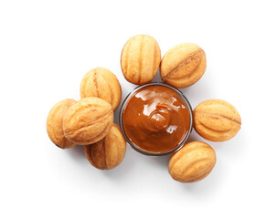Delicious nut shaped cookies with boiled condensed milk isolated on white, top view