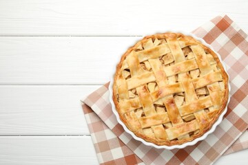 Delicious homemade apple pie on white wooden table, top view. Space for text