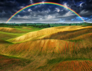 Rainbow Over Plowed Rolling Hills 