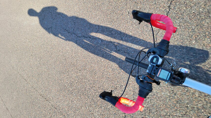 Cockpit of a bicycle including the handlebars, stem, grips, shifters, and brake levers with a bike...