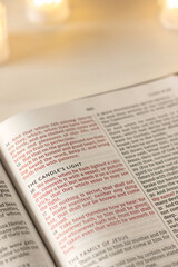 Candle's light inspirational text in open holy bible book. Faith and obedience to God Jesus Christ, Christian spiritual biblical concept.