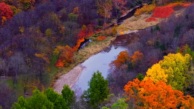 Mountains in Autumn Fall colors at Pennsylvania Grand Canyon. Scenic aerial views of canyon from above with Pine Creek and trail below used for hiking and biking vacations and relaxing