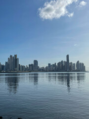 Naklejka premium Panama City, Modern skyscrapers skyline along the Cinta Costera waterfront, under a clear blue tropical sky.