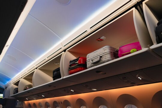 Airplane Overhead Storage Compartments Filled with Luggage &ndash; Travel Preparation