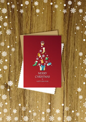 A wooden vertical surface decorated with Christmas decorations, a holiday card lies on the table, creating a warm festive atmosphere
