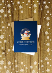 A wooden vertical surface decorated with Christmas decorations, a holiday card lies on the table, creating a warm festive atmosphere