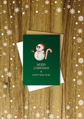 A wooden vertical surface decorated with Christmas decorations, a holiday card lies on the table, creating a warm festive atmosphere