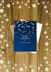 A wooden vertical surface decorated with Christmas decorations, a holiday card lies on the table, creating a warm festive atmosphere