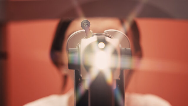 Patient undergoing vision examination with advanced ophthalmic equipment, bright light illuminating the eye, showcasing the importance of eye health and professional care in ophthalmology