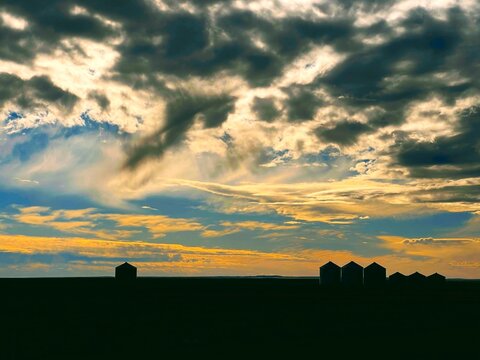 An epic sunset over Montana grain bins