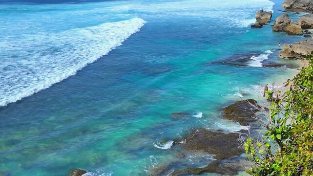 Majestic view of Bali, Indonesia rocky shores where calm waves touch stones, demonstrating nature harmony and beauty, slow motion