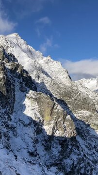 Velka Studena dolina, View from Strbavy hreben, Vysoke Tatry, High Tatras, Slovakia. Landscape of rocky alpine mountains in the sunny winter. Vertical panning video.