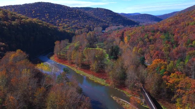 Mountains in Autumn Fall colors with peaceful creek winding through countryside in morning light in Pennsylvania, Pine Creek near Pennsylvania Grand Canyon at Blackwell, PA