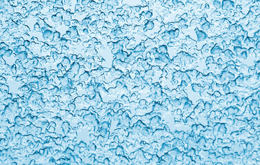 Melted ice drops on glass forming abstract pattern.