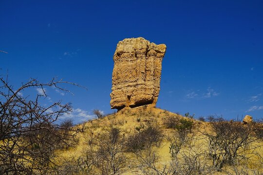 Scenic shot of the Vingerklip, a rock formation in Damaraland in northern Namibia, not far from the Ugab Terraces during the dry season. The sandstone rock needle is ancient and 35 metres high. 