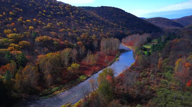 Mountains in Autumn Fall colors with peaceful creek winding through countryside in morning light in Pennsylvania, Pine Creek near Pennsylvania Grand Canyon at Blackwell, PA