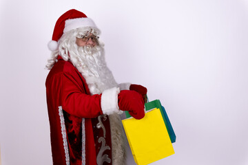Santa is holding a stack of colorful folders,possibly representing the naughty