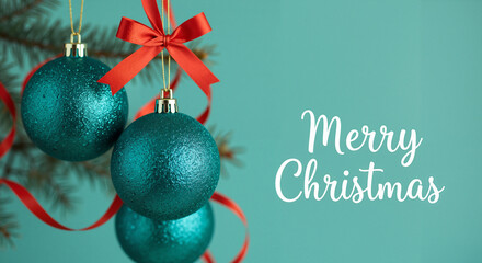 Teal Christmas ornaments with red ribbon and festive background  