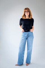 Studio portrait of blond haired female standing against isolated white background, copy space