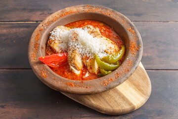 G&uuml;ve&ccedil; &agrave; la volaille, rago&ucirc;t turc traditionnel dans un plat en terre cuite sur une table en bois. R&eacute;gion de Cappadoce. Gastronomie turque. 