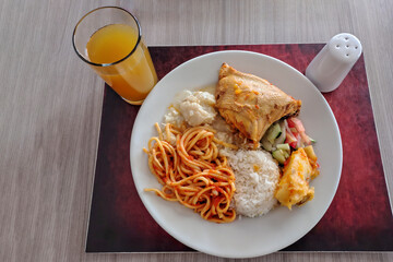 White rice, broccoli, spaghetti, chicken, and salad, basic lunch with sauce and salad