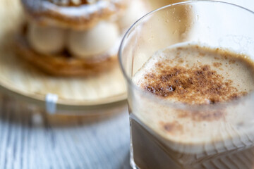 Close-Up of Pistachio and Pumpkin Christmas Paris-Brest Dessert with Pumpkin Latte
