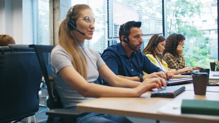 Side view of customer support team working in call center. Focused operators wearing headsets typing on keyboards. Employees providing assistance and communication services in modern office. - Powered by Adobe