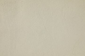 Textured beige plaster with soft tones and shadows provides a tranquil, seamless backdrop for modern interiors or abstract art.