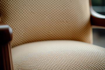 Obraz premium A close-up of a vintage armchair with a cushioned seat and back. The chair features a dark wooden armrest, adding a touch of elegance to its classic design. #vintage #armchair