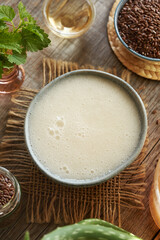 A bowl of homemade alternative natural shampoo made with flax seed gel, nettle, aloe vera, apple cider vinegar