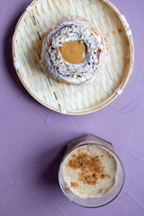 Close-Up of Pistachio and Pumpkin Christmas Paris-Brest Dessert with Pumpkin Latte
