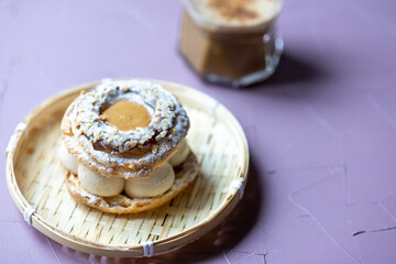Close-Up of Pistachio and Pumpkin Christmas Paris-Brest Dessert with Pumpkin Latte
