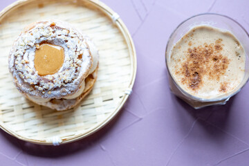Close-Up of Pistachio and Pumpkin Christmas Paris-Brest Dessert with Pumpkin Latte
