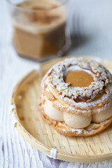 Close-Up of Pistachio and Pumpkin Christmas Paris-Brest Dessert with Pumpkin Latte
