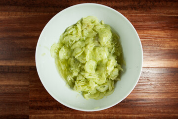 Cucumber salad in a white bowl