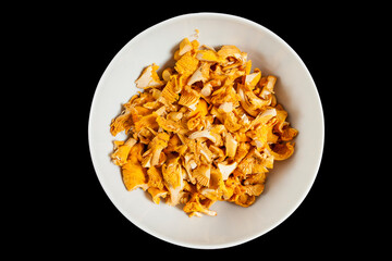Freshly cleaned chanterelles isolated on black
