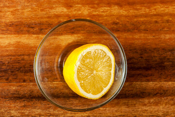 Half a lemon in a glass bowl
