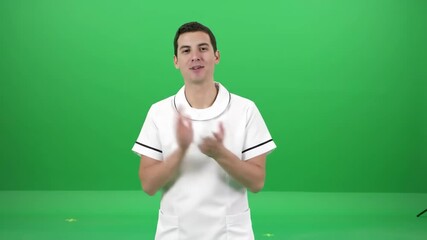 Healthcare professional in white uniform stands before a green screen.