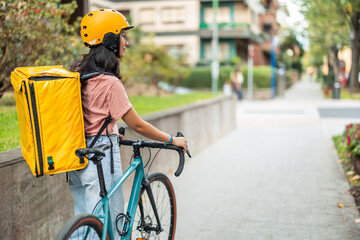 Asian woman delivering food by bicycle in city