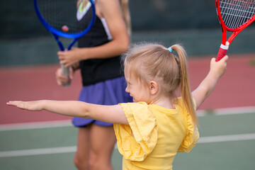 child with tennis racket
