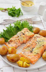 Salmon fillet with cheese, spices, baby potatoes