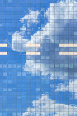 South Tower skyscraper modernism architecture style, modern high-rise office building, abstract details of facade glass curtain wall cells reflecting white clouds in blue sky, Brussels city, Belgium