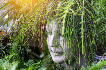 Serene Sculpture Surrounded by Greenery