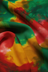 Obraz premium Abstract tie-dye fabric background with vibrant colors a soft and flowing texture perfect for textile design and fashion concepts