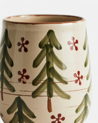 Ceramic mug with hand-painted Christmas trees and snowflakes festive holiday decor for winter isolated on white