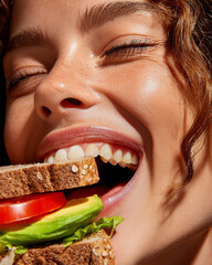 Cropped shot of beautiful woman enjoys tasty nutritional healthy sandwich with green vegetables and tomato on bread. Green lettuce, avocado. Healthy lunch and lifestyle