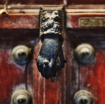 Detail of an old hand shaped door knocker, Toledo, Spain, Europe