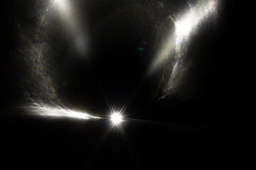Lens Flare. Light over black background. Easy to add overlay or screen filter over photos. Abstract sun burst with digital lens flare background. Gleams rounded and hexagonal shapes, rainbow halo.