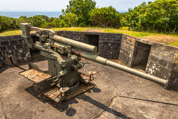 A vintage British 9.4 cm fixed anti-aircraft gun from 1940, located in a coastal fort on Terceira Island, Azores, Portugal. This preserved World War II artillery piece was part of the island’s militar