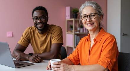 Smiling diverse colleagues posing for portrait in modern office. Senior businesswoman and young black businessman working together. Age diversity and teamwork concept